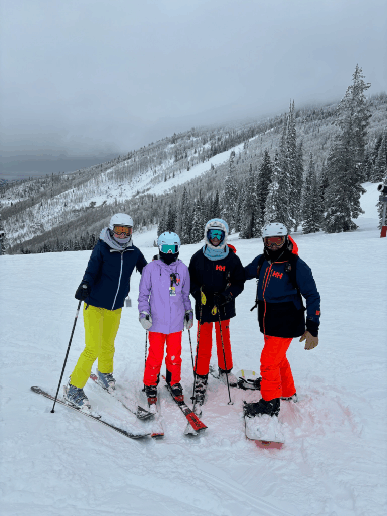 Family skiing in snowy mountains